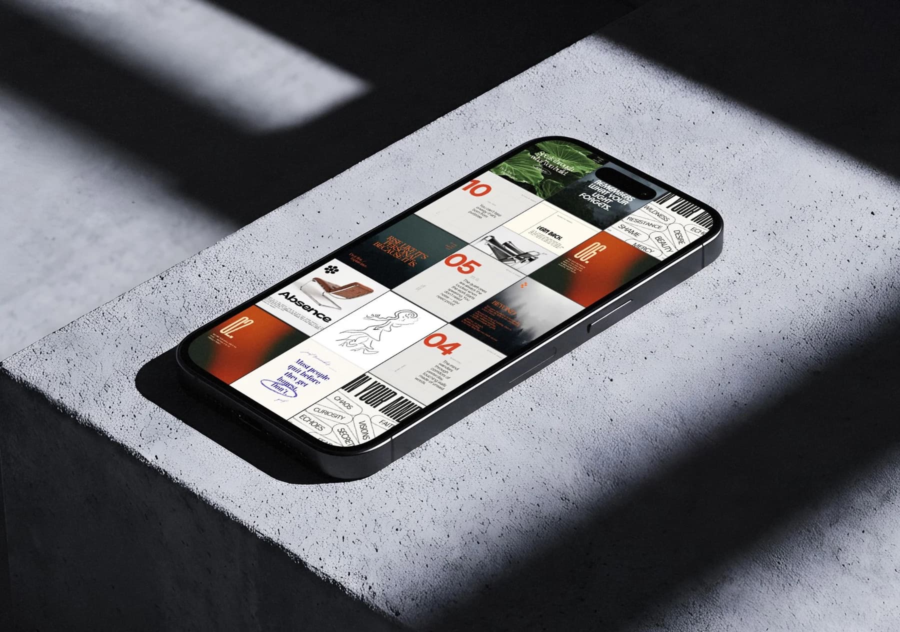 Instagram-Feed von @visuals.of.thoughts auf einem Handy, das schräg auf einer Betonkante liegt: ein Raster aus Typografie-Kacheln, großen roten Ziffern, einem grünen Blatt, einem Stuhl und einer Strichzeichnung